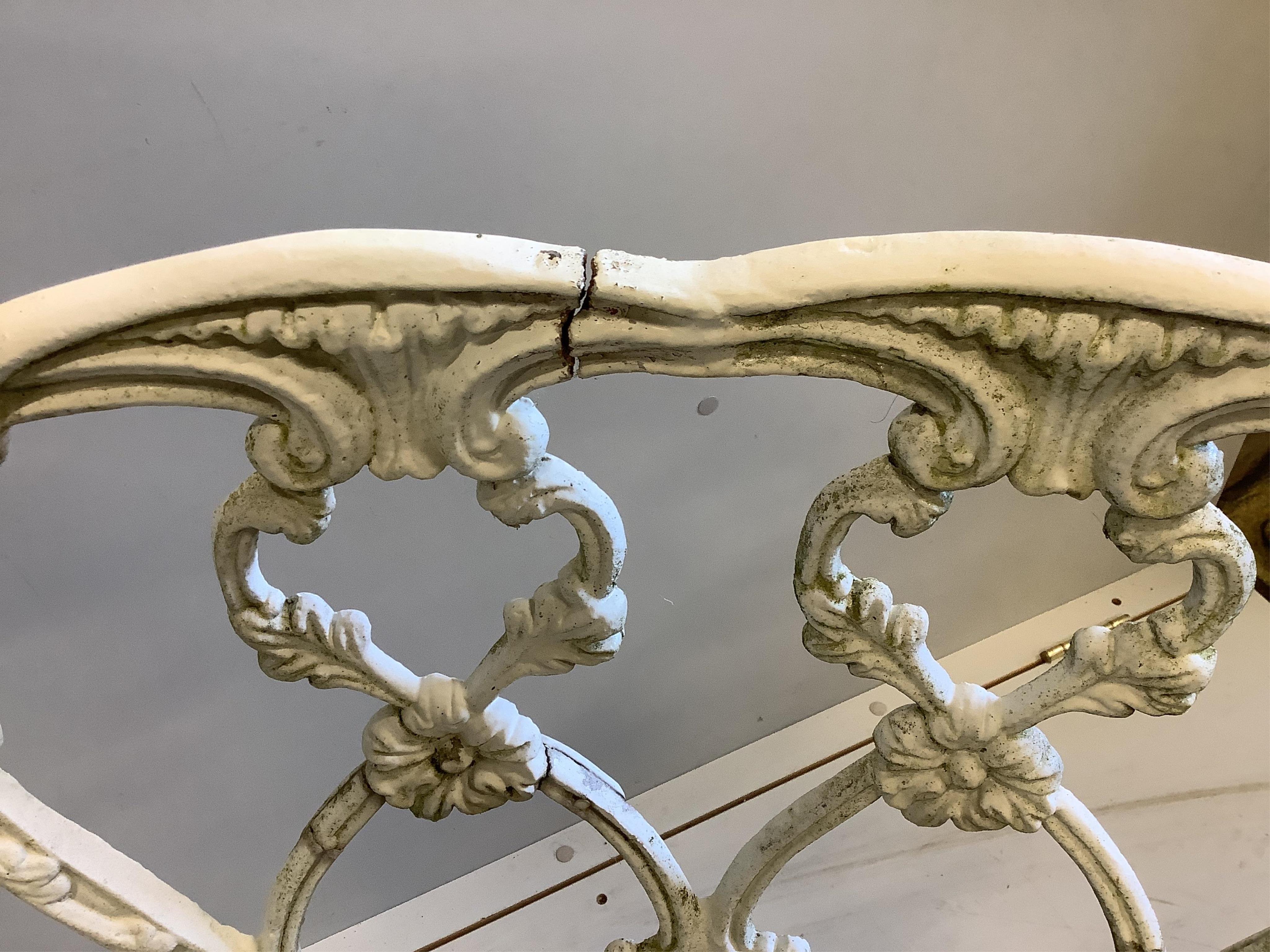 A Victorian style white painted cast aluminium three piece garden suite, bench width 126cm, depth 50cm, height 78cm and a two similar circular topped garden tables. Condition - fair